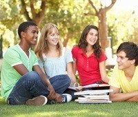 group of teenagers laughing in a park